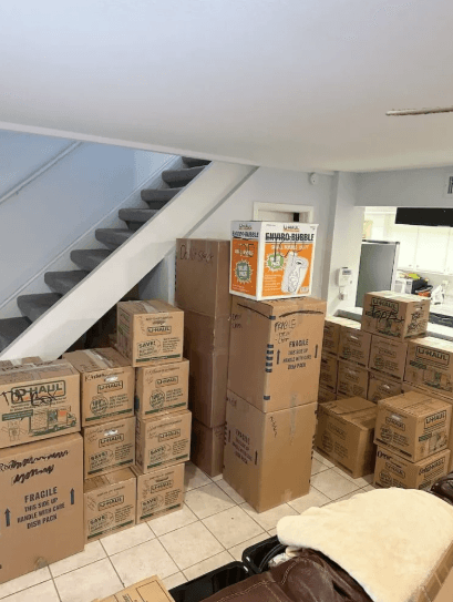 Moving boxes packed, labeled and staged by the stairs before a South Florida move — Easy Move Florida